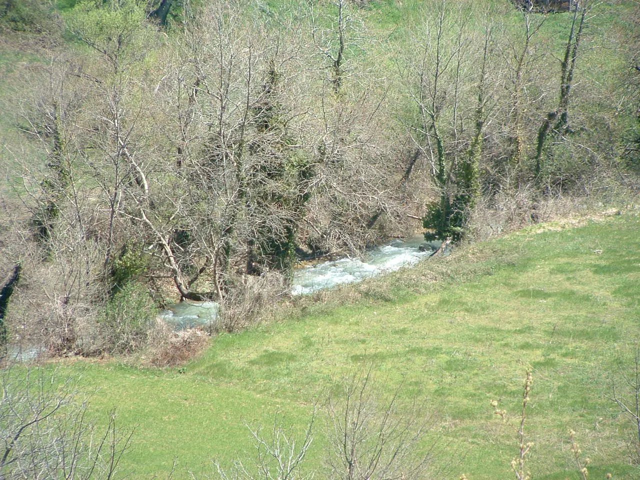 The Krathis river running through the valley below the land